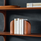 PI Book Ends in mahogany wood on the PI wall shelf.