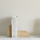 PI Book Ends in sycamore wood on a bookshelf.