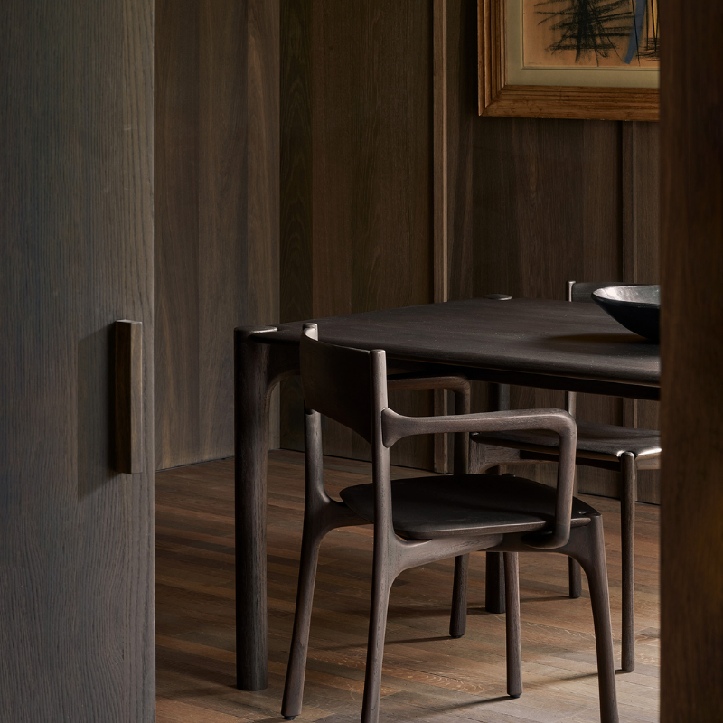 The PI Dining Chair with Armrest by Ethnicraft in the dining room.