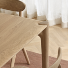 The Oak PI Dining Table by Ethnicraft in a dining room.