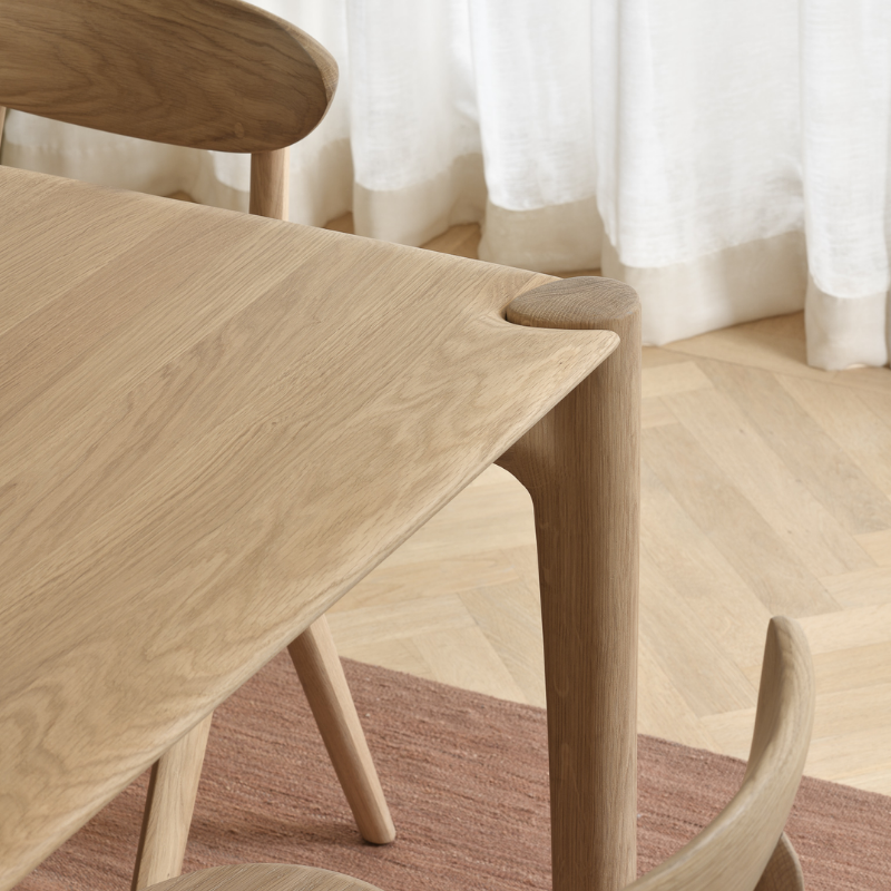 The Oak PI Dining Table by Ethnicraft in a dining room.