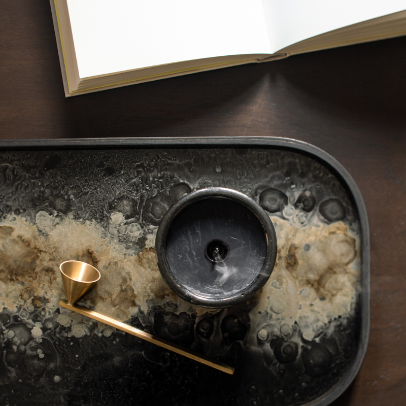 The Rectangular Organic Valet Tray Black from Ethnicraft in a living room on the table.
