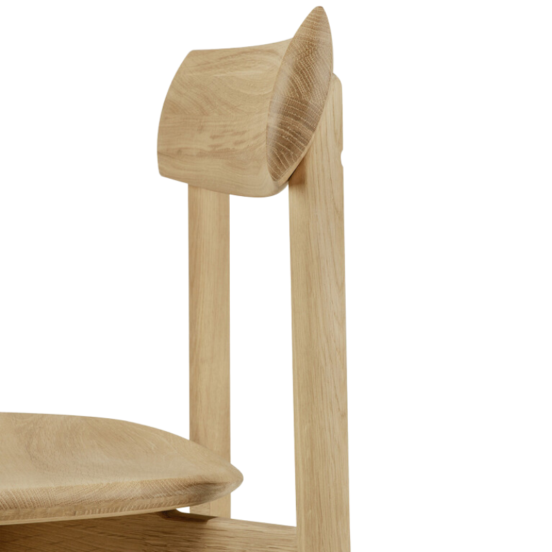 The Risu Dining Chair by Ethnicraft with a curved backrest.