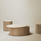 The 23.5 and 31.5 inch Roller Max Coffee Table Oak by Ethnicraft in a living room.