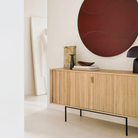 The Roller Max Sideboard from Ethnicraft in oak in a living room.