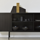 The 88-inch Roller Max Sideboard from Ethnicraft in teak off black with ceramics inside.