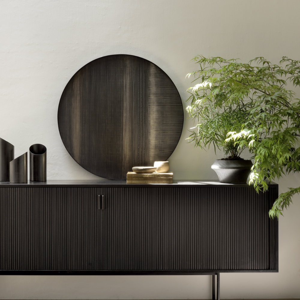 The 88-inch Roller Max Sideboard from Ethnicraft in teak off black in a living room.