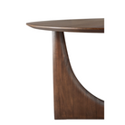 The brown teak Round Geometric Dining Table from Ethnicraft focusing on the tabletop.