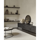 The black round Tree Wooden Tray from Ethnicraft in a dining room.