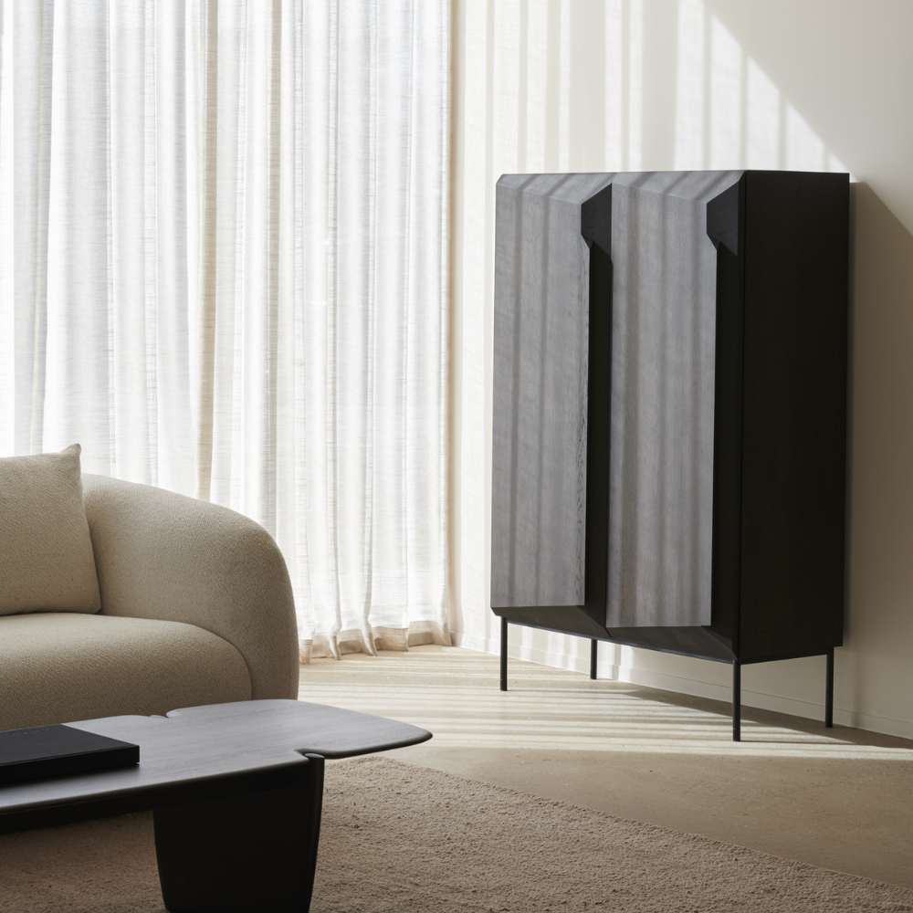 The Stairs Cupboard from Ethnicraft in a living room.