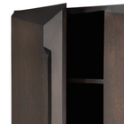 The Stairs Cupboard from Ethnicraft with the door open, close-up, focusing on the storage.