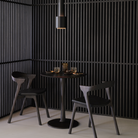 Illuminee Torsion Round Dining Table Brown Oak by Ethnicraft in a dining hall. 