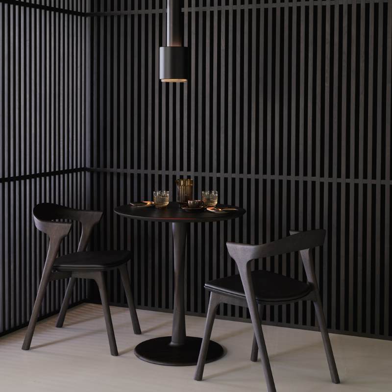 Illuminee Torsion Round Dining Table Brown Oak by Ethnicraft in a dining hall. 