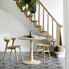 Illuminee Torsion Round Dining Table Oak by Ethnicraft in a personal family space.