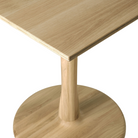 The Torsion Square Dining Table from ethnicraft with the tabletop and base details with an edge.
