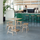 The Torsion Square Dining Table from ethnicraft in a restaurant.