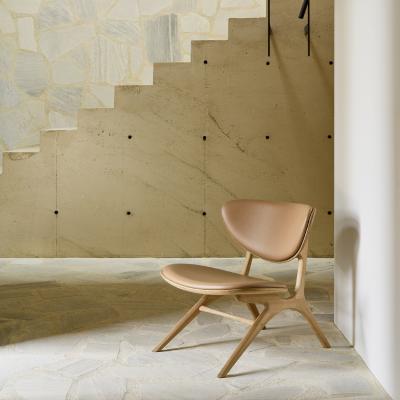 The Upholstered Eye Lounge Leather Chair by Ethnicraft in the living room.