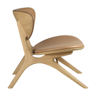 The Upholstered Eye Lounge Leather Chair by Ethnicraft from side angle.