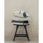 The Urban Throw from Ethnicraft in a family space with other textiles.