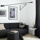 The black 265 Wall Lamp from Flos in a living space.