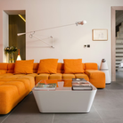 The white 265 Wall Lamp from Flos in a gathering room.