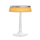The Bon Jour Table Lamp from Flos in matte chrome with plisse cloth crown.