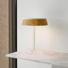 The Bon Jour Table Lamp from Flos in white with rattan crown in an office.