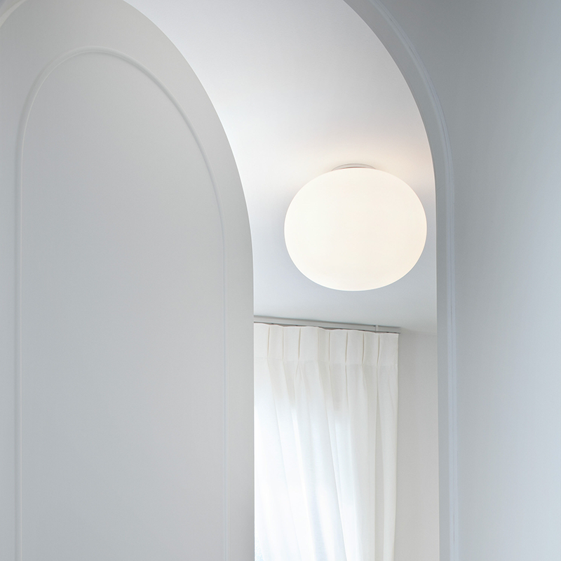 The Glo Ball 1 Ceiling Light from Flos in a guest bedroom.