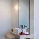 The Glo-Ball Mini Ceiling/Wall Light from Flos in a bathroom.