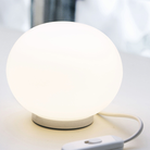 The Mini Glo-Ball Table Lamp from Flos in a home office.