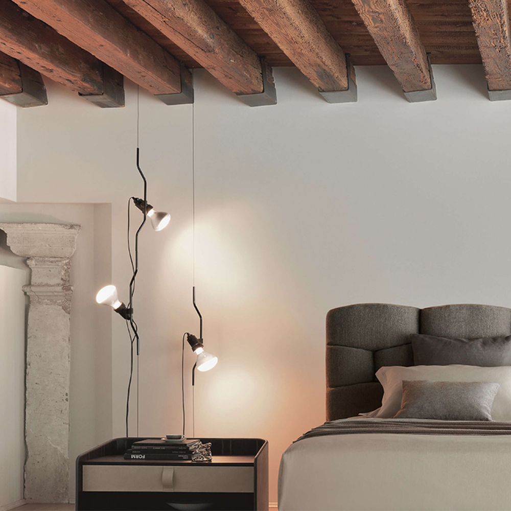 The Parentesi Lamp from Flos in Black in a bedroom.
