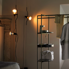The Parentesi Lamp from Flos in Black in a closet.