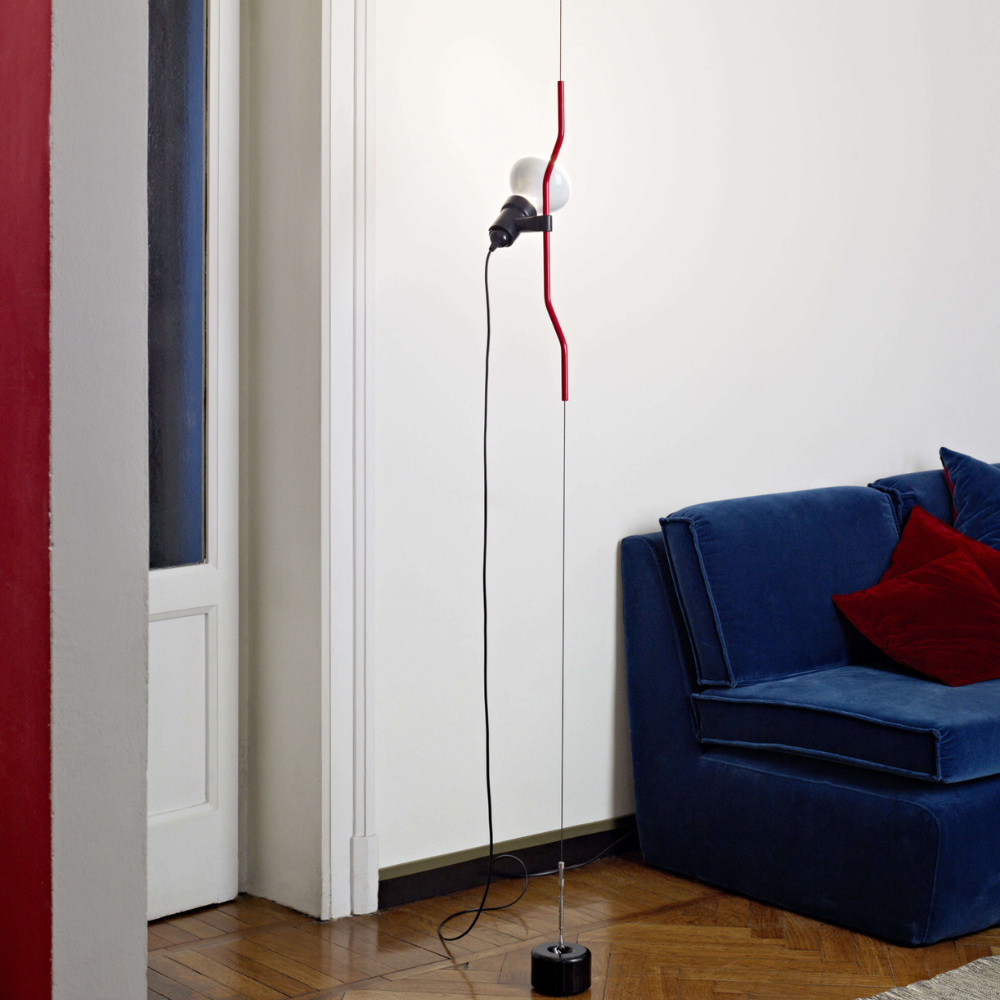 The Parentesi Lamp from Flos in Red in a living room.