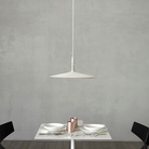 The Aplomb Large Pendant from Foscarini in white in a dining space.