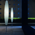 The Havana Outdoor Floor Lamp from Foscarini in a garden.