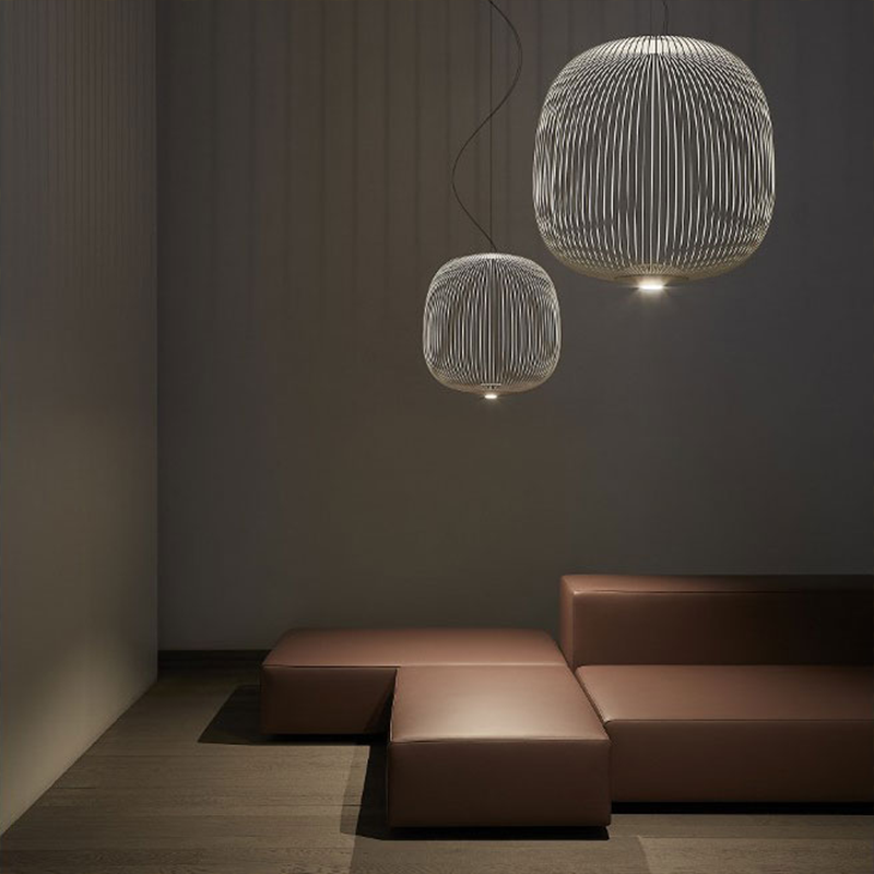 The Spokes 2 Pendant from Foscarini in graphite in a lounge area.