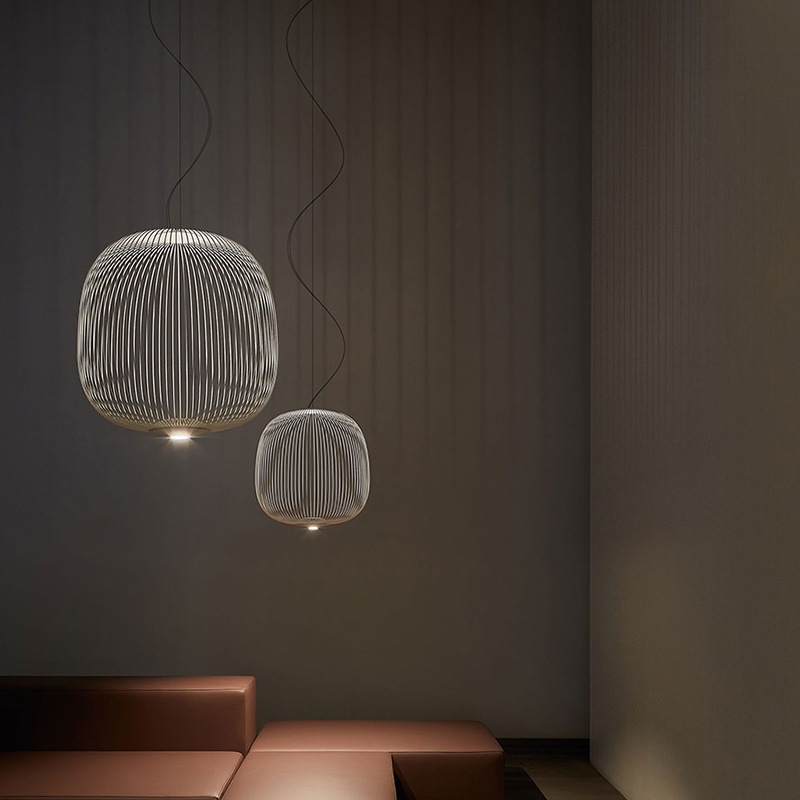 The Spokes 2 Pendant from Foscarini in graphite in a lounge.