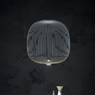 The Spokes 2 Pendant from Foscarini in large matte black hangs in a primary bedroom.