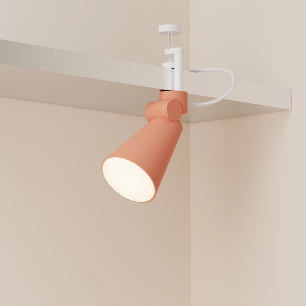 The blossom Aim Clamp Light from Gantri with the white clamp.