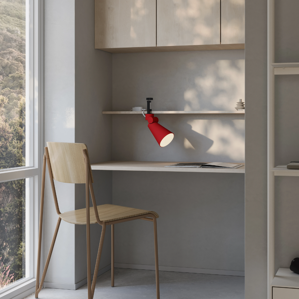 The canyon Aim Clamp Light from Gantri with the black clamp in a home office.