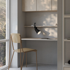 The carbon Aim Clamp Light from Gantri with the black clamp in a home office.