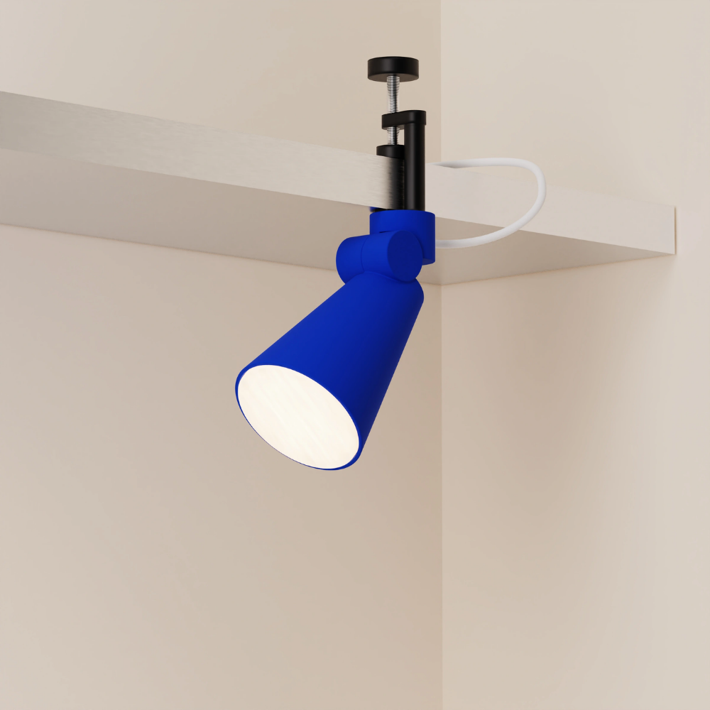 The cobalt Aim Clamp Light from Gantri with the black clamp.