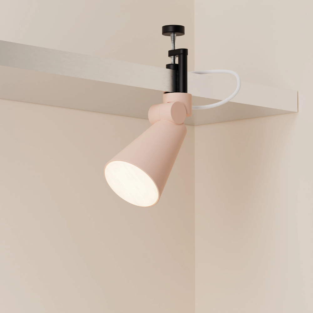 The coral Aim Clamp Light from Gantri with the black clamp.