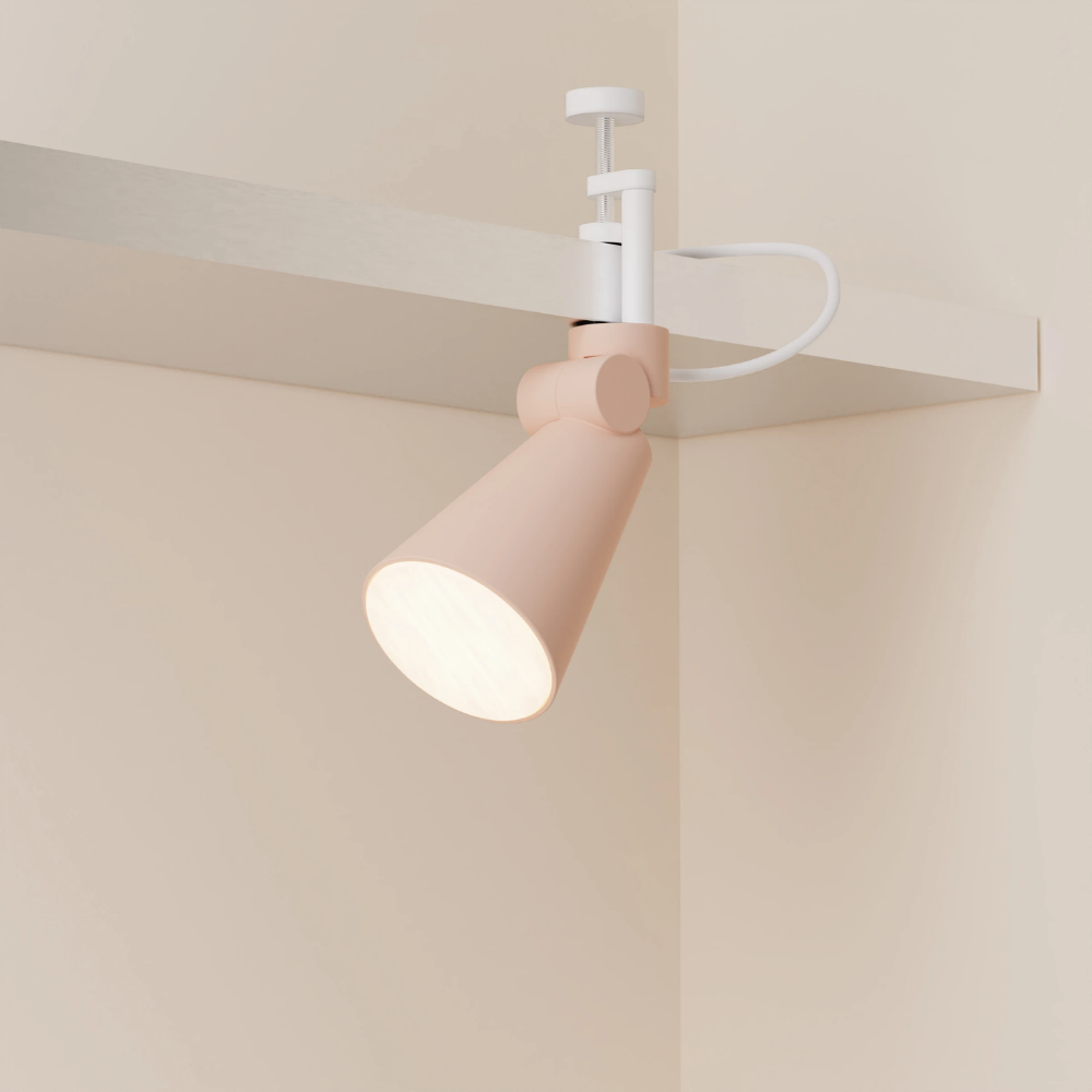 The coral Aim Clamp Light from Gantri with the white clamp.