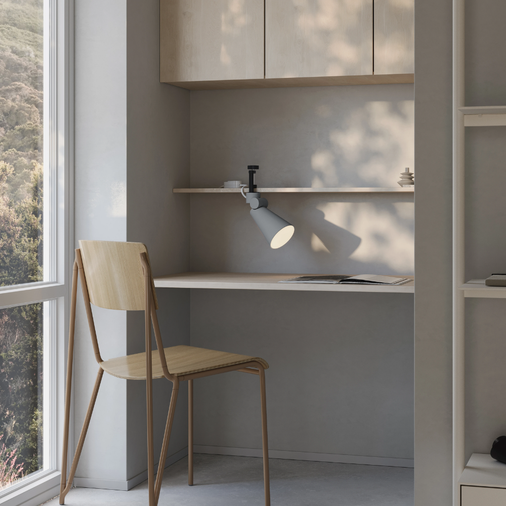 The fog Aim Clamp Light from Gantri with the black clamp in a home office.
