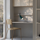 The forest Aim Clamp Light from Gantri with the black clamp in a home office.