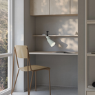 The meadow Aim Clamp Light from Gantri with the black clamp in a home office.