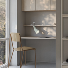 The meadow Aim Clamp Light from Gantri with the white clamp in a living room.