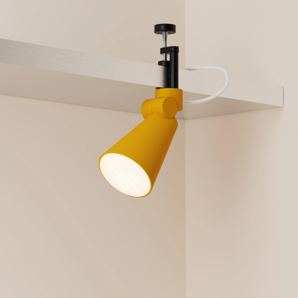 The mustard Aim Clamp Light from Gantri with the black clamp.