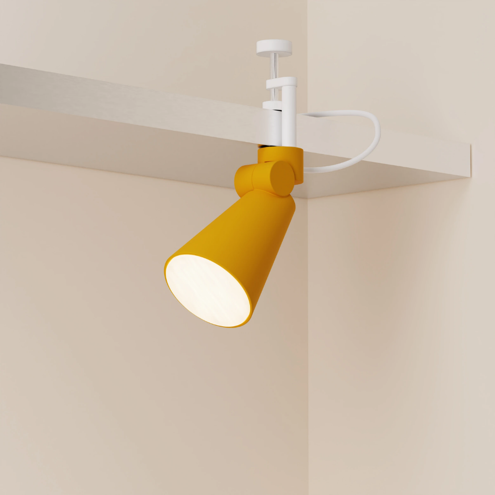 The mustard Aim Clamp Light from Gantri with the white clamp.